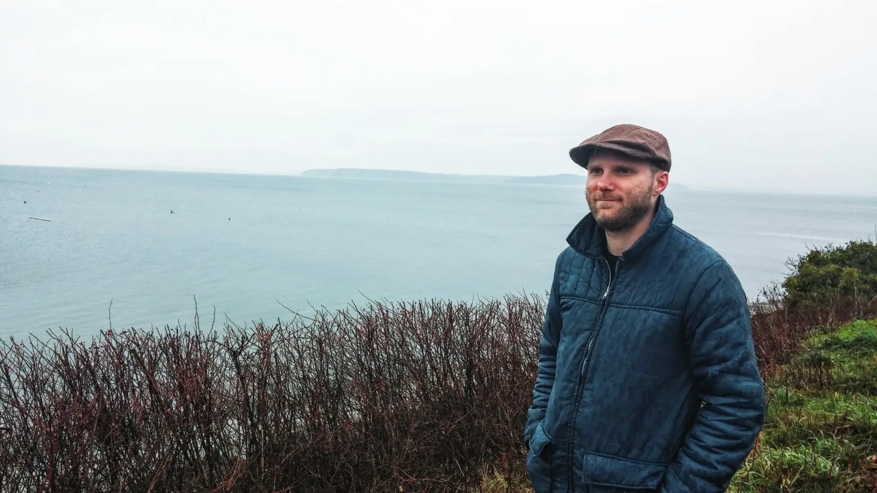 Dylan standing beside the sea